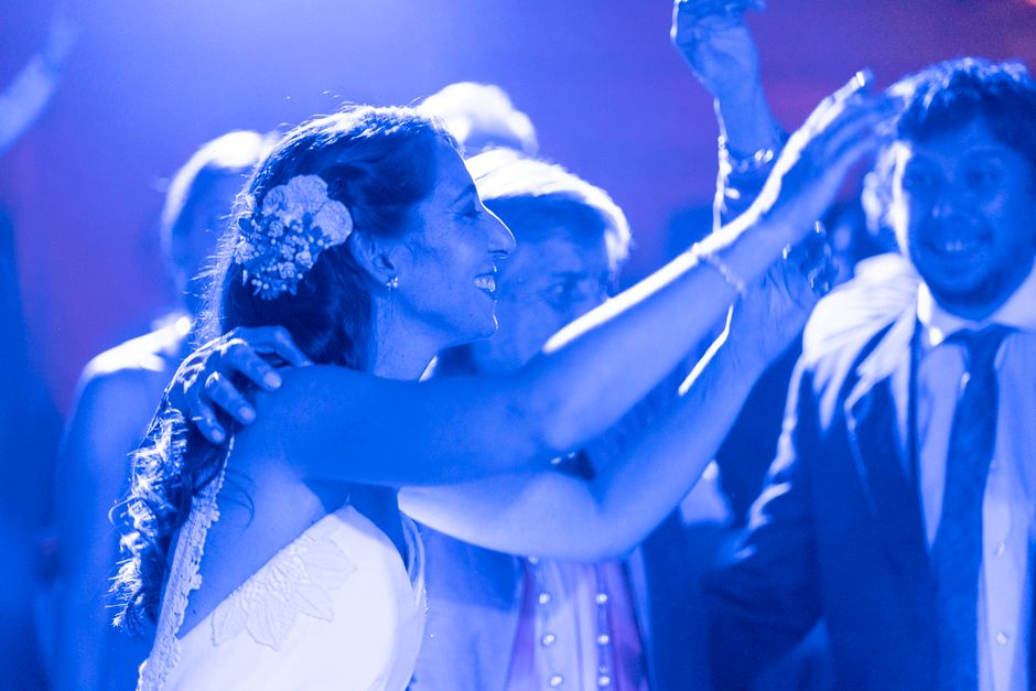 Joyful couple and guests dancing at a wedding reception
